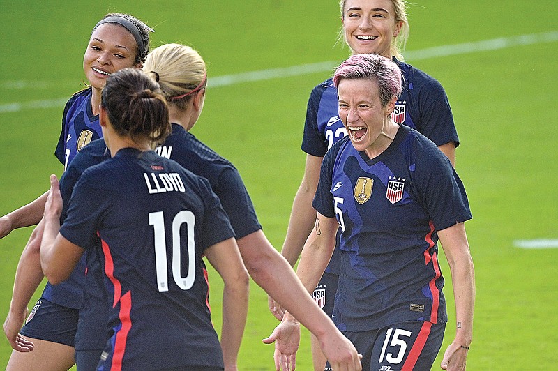 Megan Rapinoe (15) celebrates with her U.S. teammates Sunday after scoring a goal during the second half of a SheBelieves Cup match against Brazil in Orlando, Fla.