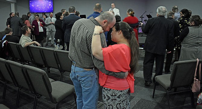 Joseph and Heather Petershagen focus on each other as they and other married couples renew their vows during Landmark Church's Sunday service.