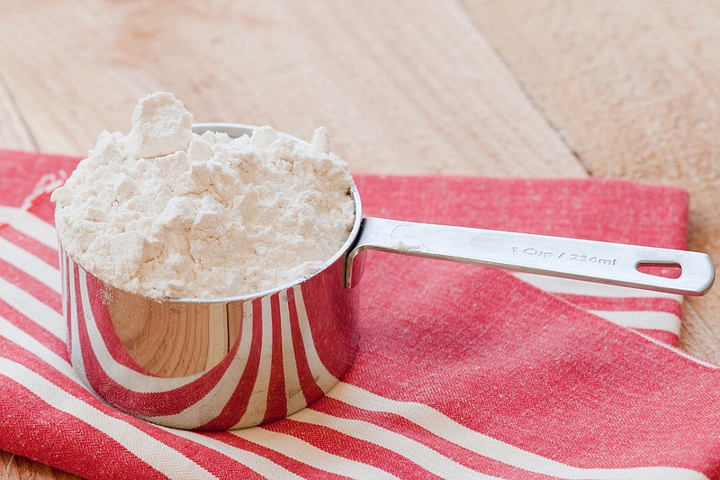 Some recipe developers reach their weight measurement by spooning flour delicately into a cup, while others call for scooping the cup into a canister, which obviously makes the measurement a little heavier. (Dreamstime/TNS)