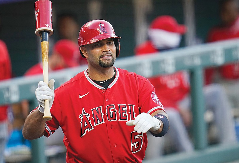In this Sept. 12, 2020, file photo, Angels designated hitter Albert Pujols waves to players in the Rockies dugout during a game in Denver.