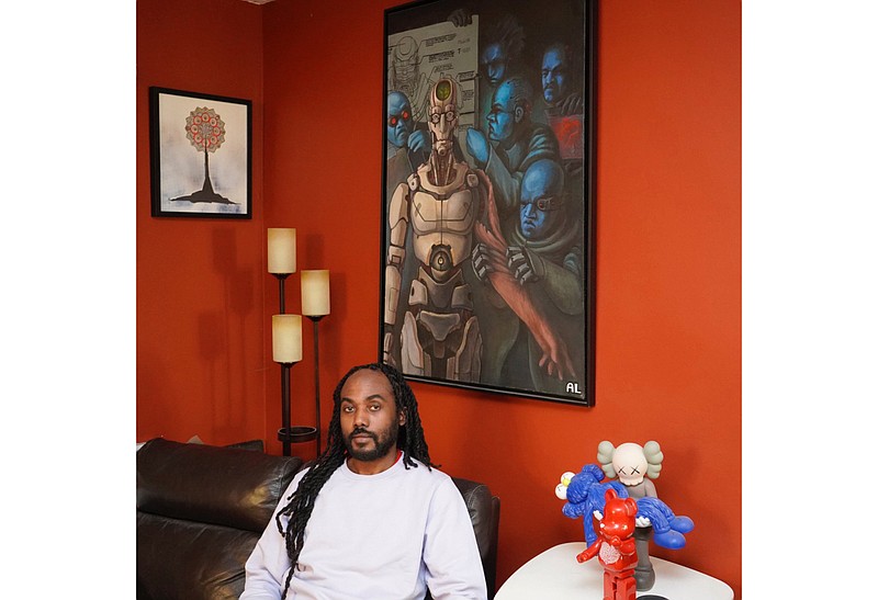 Atiba T. Edwards appears in his apartment in the Brooklyn borough of New York on Monday, Feb. 22, 2021. Edwards is the cofounder of the arts nonprofit FOKUS, which offers arts education, hosts art events and publishes an online magazine. (Atiba Edwards via AP)