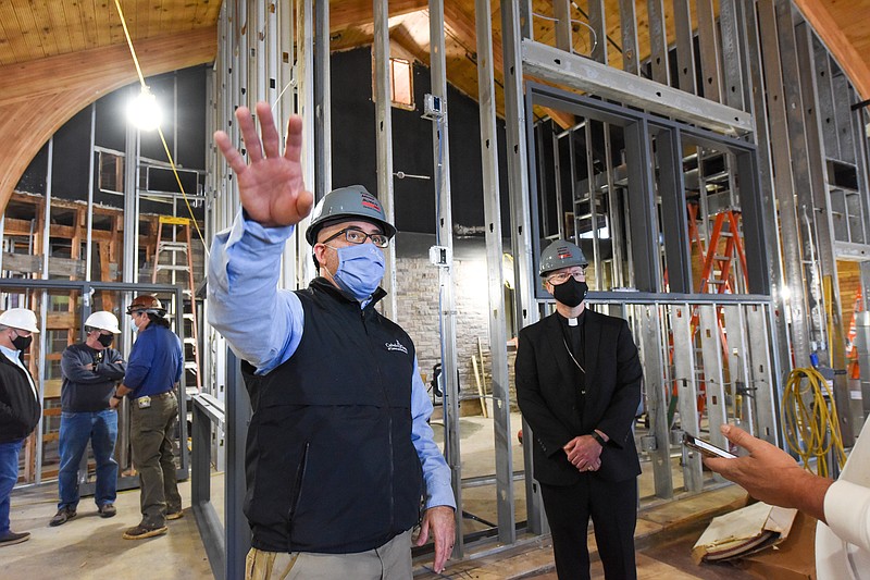 Julie Smith/News Tribune
Bishop Shawn McKnight, middle, listens as Dan Lester, left, points out some of the features and changes made during a tour of the Catholic Charities of Central and Northern Missouri new facility Tuesday. Lester is executive director of CCCNM, the Catholic non-profit agency that purchased Shikles Center from the Jefferson City Housing Authority and began renovation of it last year. Areas of the building will include rooms for medical use, open area for gatherings, meetings, tutoring, etc., a chapel and office space. In addition, room is being added on the lower level for bulk food storage where individuals will be able to select food items much like in a grocery store.