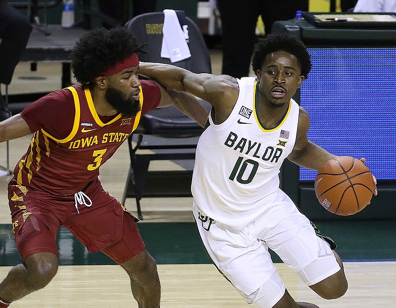 Baylor guard Adam Flagler (10) drives the ball against Iowa State guard Tre Jackson (3) in the second half of an NCAA college basketball game, Tuesday, Feb. 23, 2021, in Waco, Texas. (AP Photo/Jerry Larson)