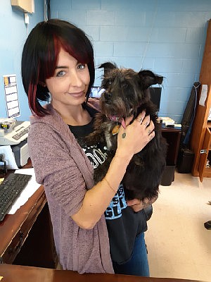 In this December 2019 photo, Kayla Tucker, then interim director of the Texarkana Animal Care and Adoption Center, poses for a photo with a dog named Velvet. Tucker resigned her position as the shelter's director Monday. (Staff photo by Staff file photo by Junius Stone)