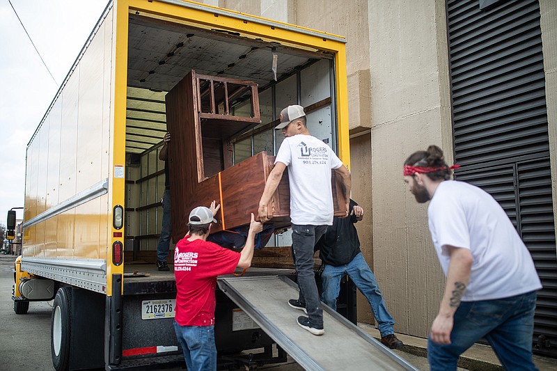 Rogers Construction staff unloads a desk outside of the Landmark building, which is the new home of several Miller County offices that are displaced due to the damage the courthouse suffered last week.