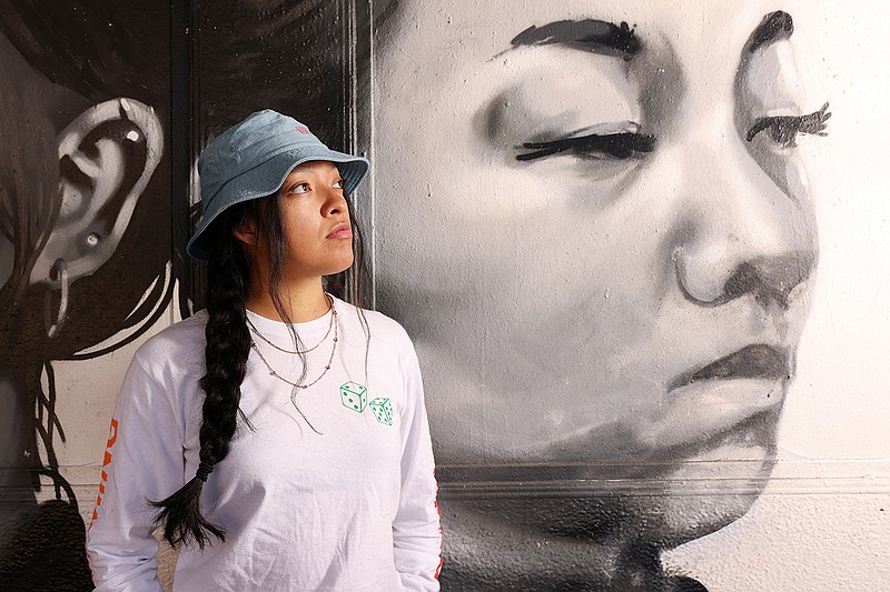 Alepsis Hernández stands before her first paid commission, a mural at the Homeland Cultural Center in Long Beach. (Dania Maxwell/Los Angeles Times/TNS)