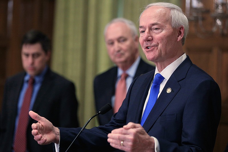 In this March 23, 2020 file photo, Gov. Asa Hutchinson, right, speaks in Little Rock, Ark. Hutchinson said Sunday, Feb. 21, 2021, he will not back former President Donald Trump if he runs for the White House in 2024, saying "it's time" to move on to different voices in the Republican Party.  (Staton Breidenthal/The Arkansas Democrat-Gazette via AP, File)
