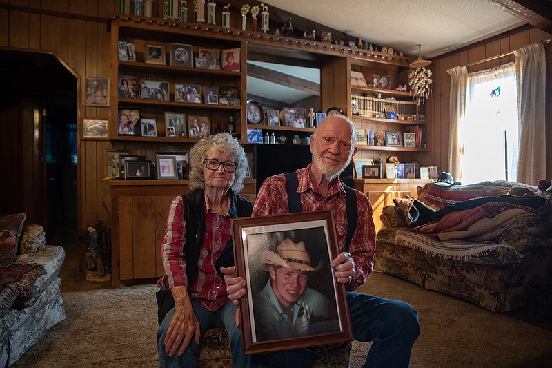 Bill and Sybil Waggoner pose in their living room holding a photo of their late grandson, TJ Waggoner. The couple have dedicated many years to raising money to donate to Arkansas Children's Hospital in honor of TJ.