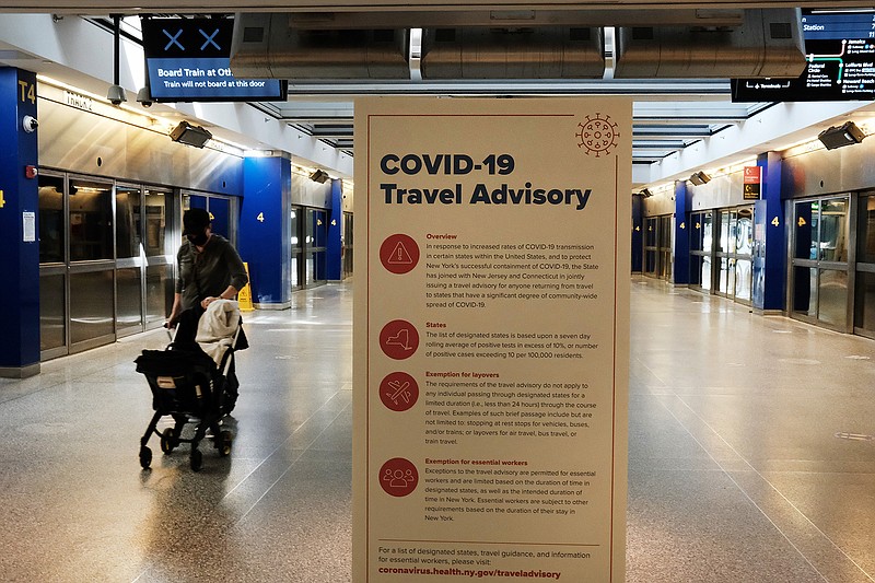 COVID-19 information is displayed at an international terminal at John F. Kennedy Airport (JFK) on January 25, 2021, in New York City. (Spencer Platt/Getty Images/TNS)