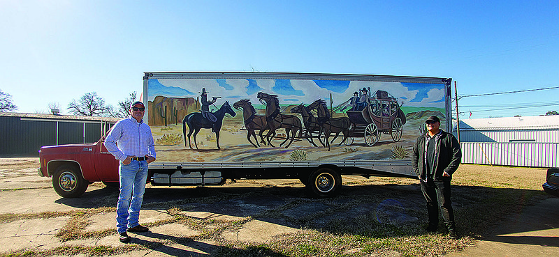 David Stone, left, and muralist David Freeman pose in front of Stone's 1-ton GMC hauler truck. Freeman painted a "Smokey and the Bandit"-themed mural on the vehicle that Stone intends to sell along with a vintage Trans Am.