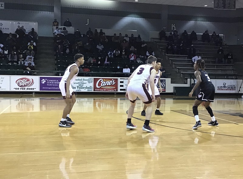 Atlanta's Kim Dickerson, left, Alex Boston (3) and Caleb Hamilton converge on defense against Arp's Johnathan Blackwell during the first quarter of a Class 3A boys area basketball game Thursday at Longview's Lobo Coliseum.