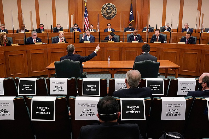 Curtis Morgan, the CEO of Vistra Corp., at table left, testifies as the Committees on State Affairs and Energy Resources holds a joint public hearing to consider the factors that led to statewide electrical blackouts, Thursday, Feb. 25, 2021, in Austin, Texas. The hearings were the first in Texas since a blackout that was one of the worst in U.S. history, leaving more than 4 million customers without power and heat in subfreezing temperatures. (AP Photo/Eric Gay)