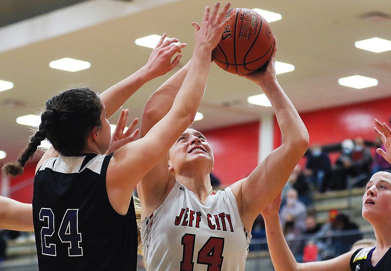 Kara Daly of Jefferson City grabs a rebound during Thursday night's game against Hickman at Fleming Fieldhouse.
