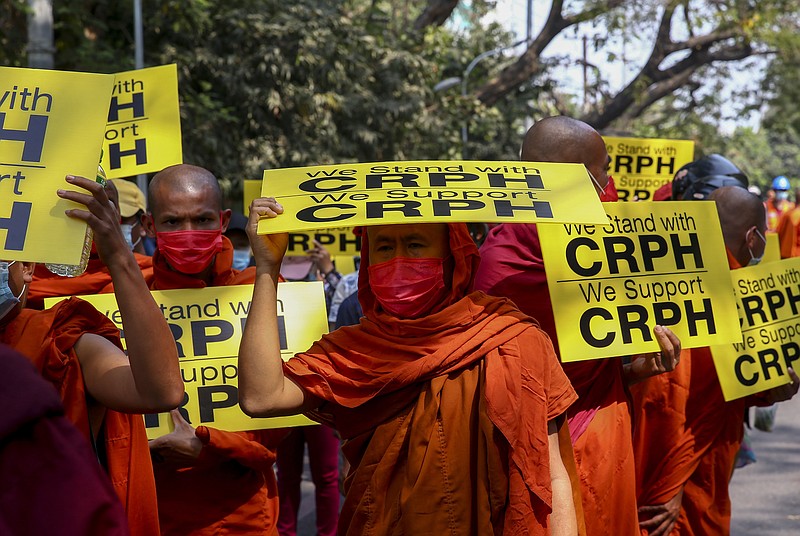 Buddhist monks lead an anti-coup protest march in Mandalay, Myanmar, Saturday, Feb. 27, 2021. Myanmar security forces cracked down on anti-coup protesters in the country's second-largest city Mandalay on Friday, injuring at least three people, two of whom were shot in the chest by rubber bullets and another who suffered a wound on his leg. "CRPH" in the placards stand for "Committee Representing Pyidaungsu Hluttaw." (AP Photo)