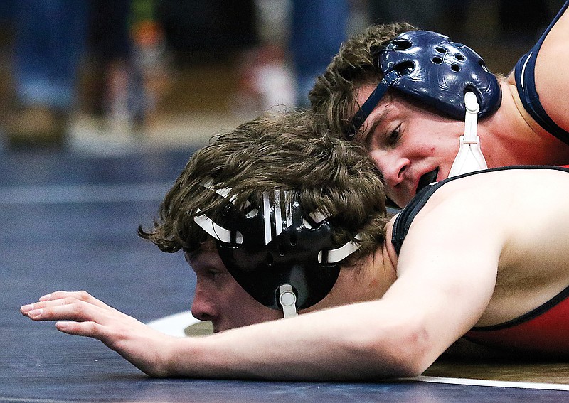 Nikolai Careaga of Helias holds down Southern Boone's Austin Skaggs in the first-place match at 152 pounds in Saturday's Class 2 Sectional 2 Tournament at Rackers Fieldhouse.