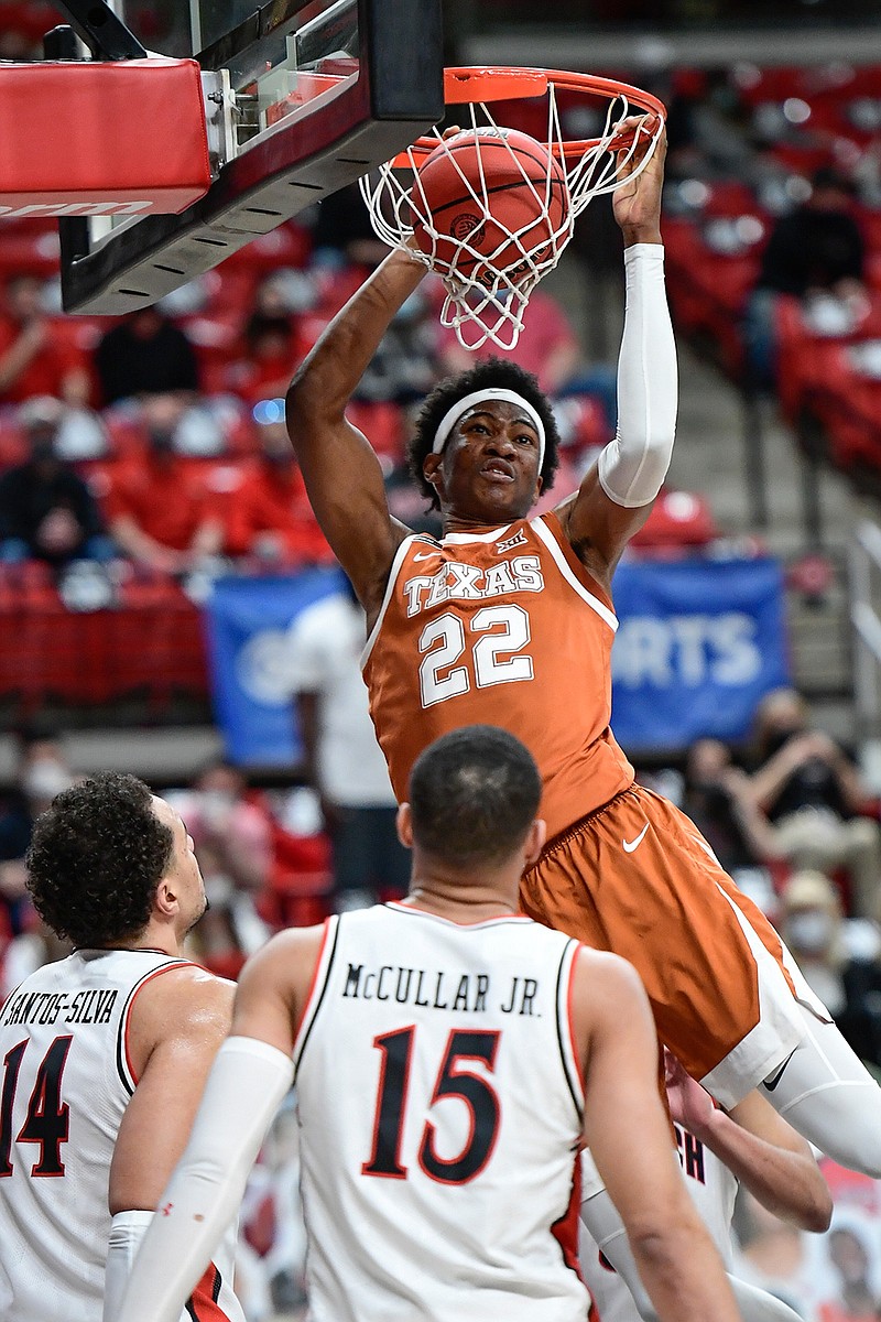 Texas' Kai Jones (22) dunks the ball during the first half of an NCAA college basketball game against Texas Tech in Lubbock, Texas, Saturday, Feb. 27, 2021. (AP Photo/Justin Rex)