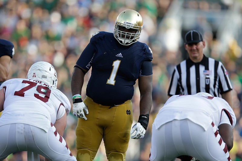 FILE - In this Saturday, Aug. 31, 2013, file photo, Notre Dame defensive lineman Louis Nix III (1) prepares to get into his defensive stance during the second half of an NCAA college football game against Temple in South Bend, Ind. Nix's mother, Stephanie Wingfield, says authorities told her that her son had died but they were unable to give her more information about his death. The Jacksonville Sheriff's Office said in a tweet Saturday, Feb. 27, 2021, that Nix was located, but didn't give any other details. (AP Photo/Michael Conroy, File)