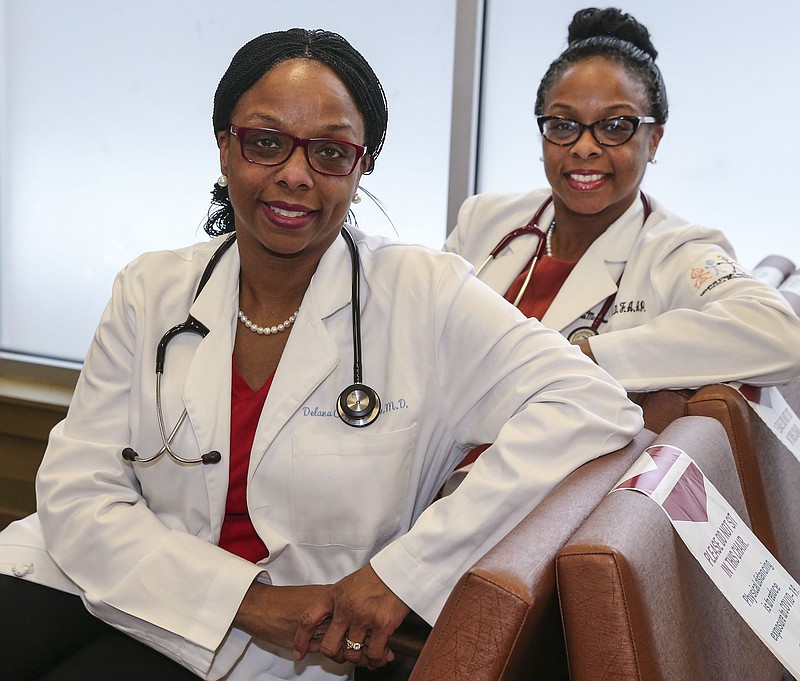 Dr. Delana Wardlaw (left) and Dr. Elana McDonald, both 46, are identical twin doctors who grew up in North Philly. Both graduated together from Central High School, Temple University, and Penn State Medical School school and have separate medical practices in Philly dedicated to serving underserved people and encouraging them to be empowered health consumers. They were involved in the Black Doctors COVID-19 Consortium early on, and have their own organization, too. Friday, February 19, 2021.  (Steven M. Falk/Philadelphia Inquirer/TNS)