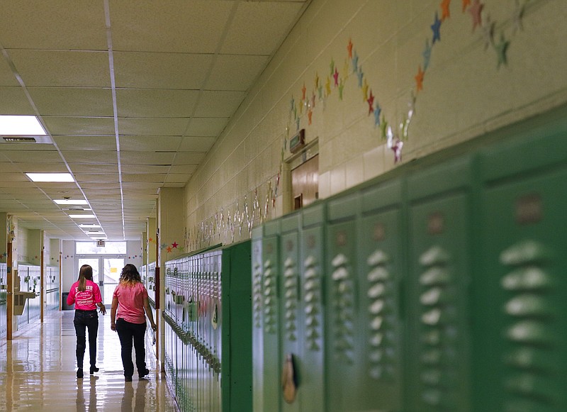 Blair Oaks junior Courtney Buscher and sophomore Emma Sandbothe walk down the halls of Blair Oaks High School on Friday, Feb. 26, 2021, making their way around the school to put up posters in preparation of the Random Acts of Kindness club's Anti-Bullying Week. 