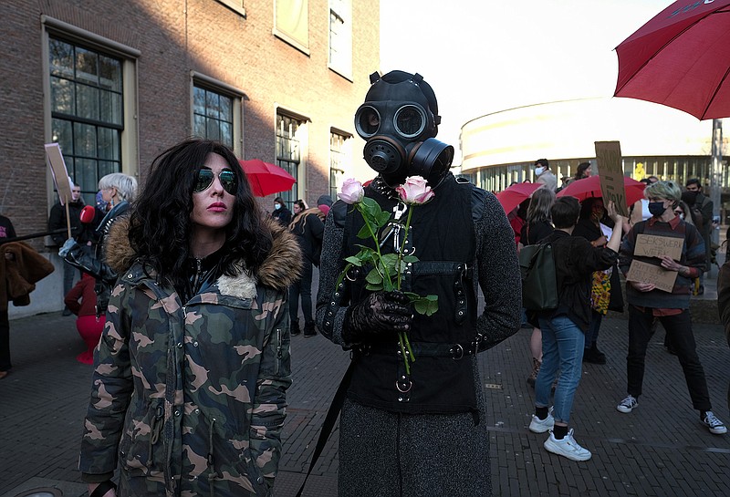 Sex workers protest unequal treatment and stigmatizing during a demonstration in The Hague, Netherlands, Tuesday, March 2, 2021. Stores in one village opened briefly, cafe owners across the Netherlands were putting tables and chairs on their outdoor terraces and sex workers demonstrated outside parliament in protests against the government's tough coronavirus lockdown. (AP Photo/Patrick Post)