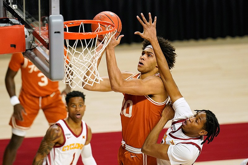 Texas forward Jericho Sims drives to the basket ahead of Iowa State forward Javan Johnson, right, during the first half of an NCAA college basketball game, Tuesday, March 2, 2021, in Ames, Iowa. (AP Photo/Charlie Neibergall)