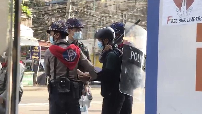 In this image made from video taken on Feb. 27, 2021, Associated Press journalist Thein Zaw is arrested by police in Yangon, Myanmar. Authorities in Myanmar have charged Thein Zaw and five other members of the media with violating a public order law that could see them imprisoned for up to three years. The six were arrested while covering protests against the Feb. 1 military coup in Myanmar that ousted the elected government of Aung San Suu Kyi. (AP Photo)