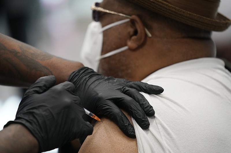 FILE - In this Feb. 10, 2021, file photo, a man receives a COVID-19 vaccine in North Las Vegas.  Catholic leaders in New Orleans and St. Louis are advising Catholics that the COVID-19 vaccine from Johnson & Johnson is “morally compromised” because it's produced using cell lines developed from aborted fetuses. Archdiocese statements in each city say Catholics should choose coronavirus vaccines made by Moderna or Pfizer — if they are available. Johnson & Johnson stresses in a statement Tuesday, March 2,  that no fetal tissue is used in the vaccine. (AP Photo/John Locher, File)