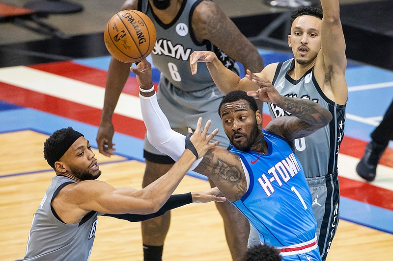 Houston Rockets guard John Wall (1) passes back out after a drive during the first half of an NBA basketball game against the Brooklyn Nets Wednesday, March 3, 2021, in Houston. (Mark Mulligan/Houston Chronicle via AP)