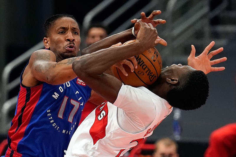 Detroit Pistons guard Rodney McGruder (17) fouls Toronto Raptors forward Chris Boucher (25) during the first half of an NBA basketball game Wednesday, March 3, 2021, in Tampa, Fla. (AP Photo/Chris O'Meara)