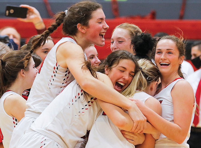 Jefferson City players (from left) Hannah Linthacum, Sarah Linthacum, Hannah Nilges and Leah Kolb share a hug after winning Thursday's Class 6 District 9 Tournament championship game against Capital City at Fleming Fieldhouse.
