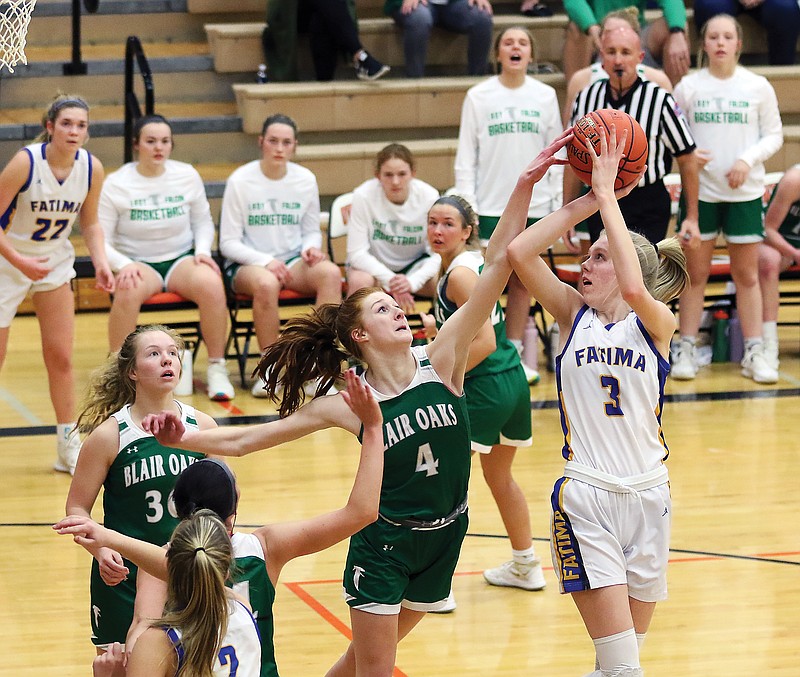 Autumn Bax of Blair Oaks blocks the shot of Fatima's Morgan Luebbering during Friday's Class 4 District 9 Tournament championship game in Owensville.