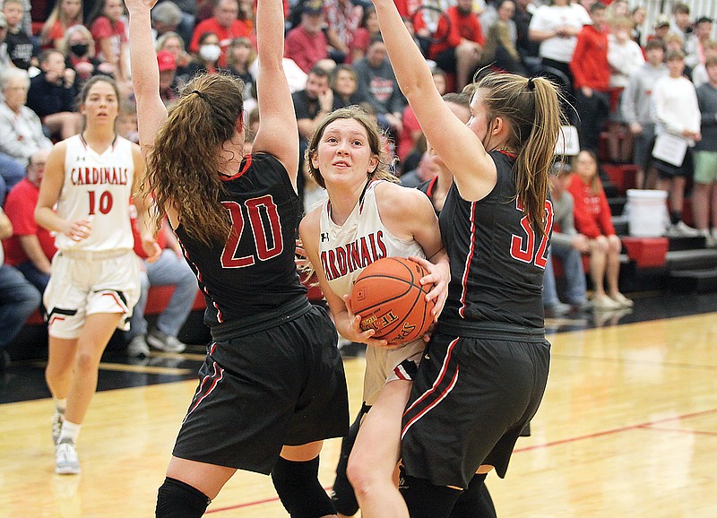 Tipton's Myra Claas tries to squeeze her way into the lane between Clark County's Brooklyn Howe (left) and Bre Chamley (right) during the first half of Saturday's Class 3 quarterfinal in Tipton.