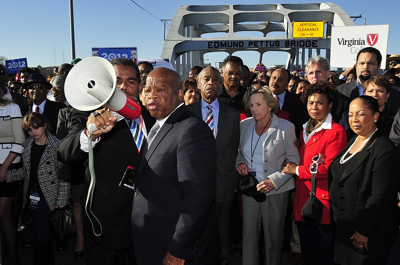 FILE - In this March 4, 2012, file photo, U.S. Rep. John Lewis, D-Ga., center, talks with those gathered on the historic Edmund Pettus Bridge during the 19th annual reenactment of the "Bloody Sunday" Selma to Montgomery civil rights march across the bridge in Selma, Ala. The March 7, 2021, Selma Bridge Crossing Jubilee will be the first without the towering presence of Lewis, as well as the Rev. Joseph Lowery, the Rev. C.T. Vivian and attorney Bruce Boynton, who all died in 2020. (AP Photo/Kevin Glackmeyer, File)