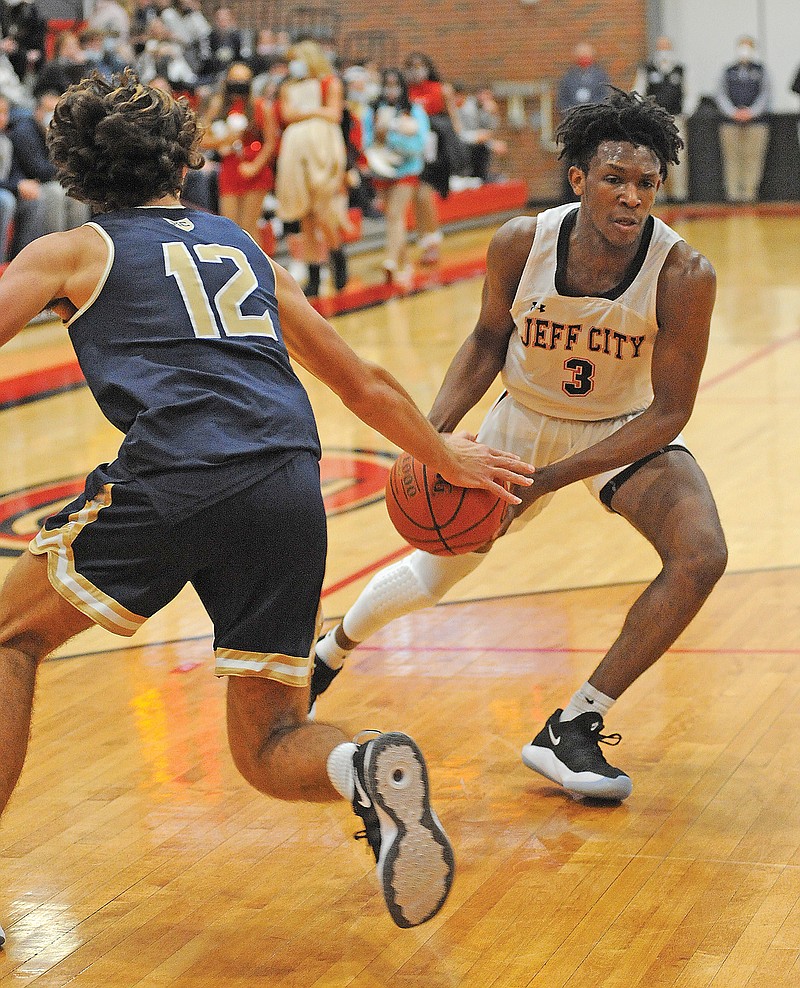 Aaron Stallings of the Jays tries to drive past Joe Rembecki of Helias during a game this season at Fleming Fieldhouse.