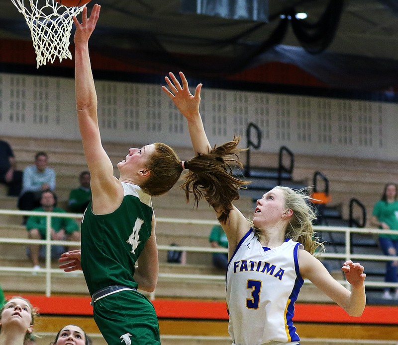 Autumn Bax of Blair Oaks shoots a layup as Fatima's Morgan Luebbering defends during last Friday night's district title game in Owensville.