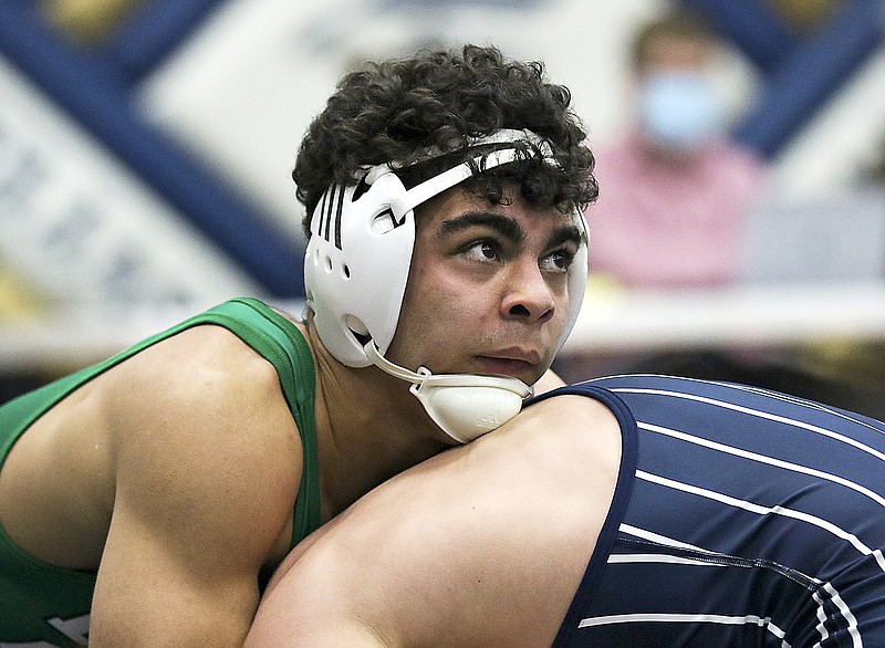 Eli Batiste of Blair Oaks looks up at the clock while wrestling against Alex Tesreau of Helias in their first-place match at 160 pounds in the Class 2 sectional tournament last month at Rackers Fieldhouse.