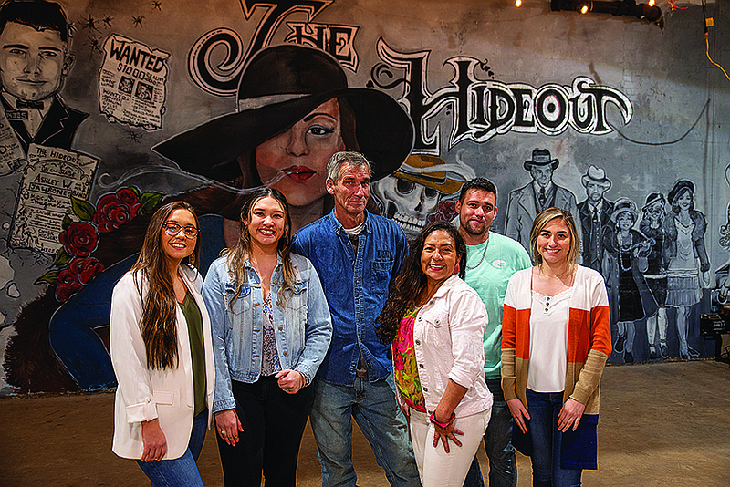 The Wright family is pictured in front of the mural at their new business, The Hideout, which will be a downtown bar and pool hall. From left to right, Ashley, Priscilla, Jeff, Irma, Christian, and Allison Wright.