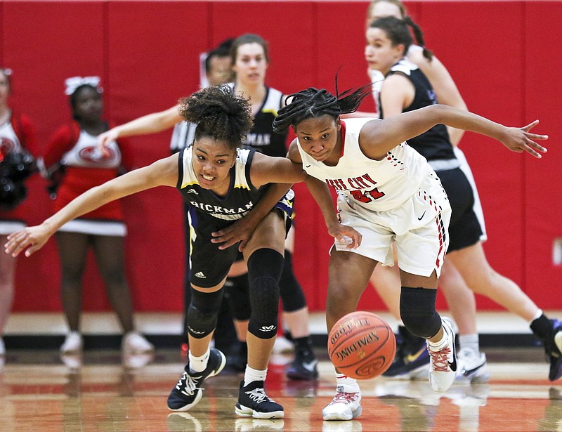 Emmarie Graham of Jefferson City chases after a loose ball with Hickman's Kalia Naylor rush after a loose ball during a game last month at Fleming Fieldhouse.