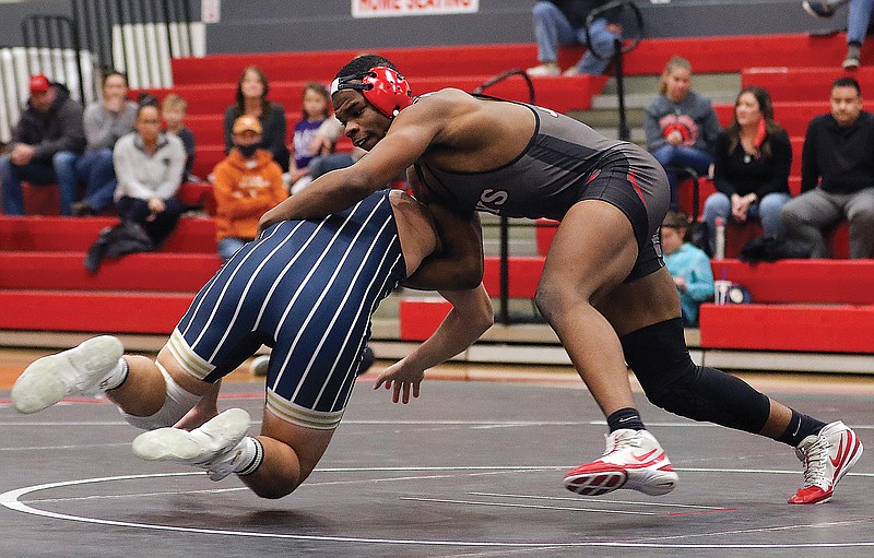 Jakeil Hayes of Jefferson City gets a takedown during a dual against Helias this season at Fleming Fieldhouse. Hayes is one of seven Jefferson City qualifiers for today's Class 4 state wrestling championships at Cable Dahmer Arena in Independence.