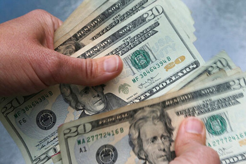 In this June 15, 2018 file photo, twenty dollar bills are counted in North Andover, Mass. A small change in spending habits may improve your chances of reaching your savings goals. Researchers have found that so-called middle savers set aside about 3% more of their salary than low savers. (AP Photo/Elise Amendola, File)