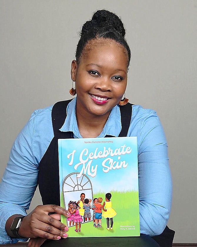 Children's author Nonku Kunene Adumetey poses with her first published book, "I Celebrate My Skin." Adumetey, who graduated from Westminster College in 2007, spoke virtually last Wednesday to the Fulton Rotary Club.