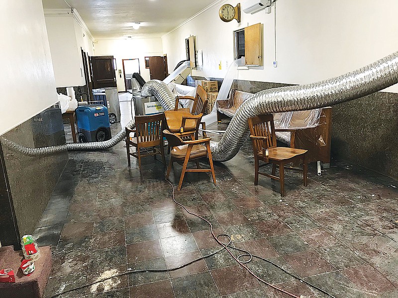 Hot air drying hoses snake their way along the Miller County Courthouse's second floor as efforts continue to get the building's interior dry following the Feb. 21 water pipe bursts suffered by the building. The recent winter blast of snow and freezing temperatures caused the pipe ruptures inside the 1939 five-floor vintage structure. 