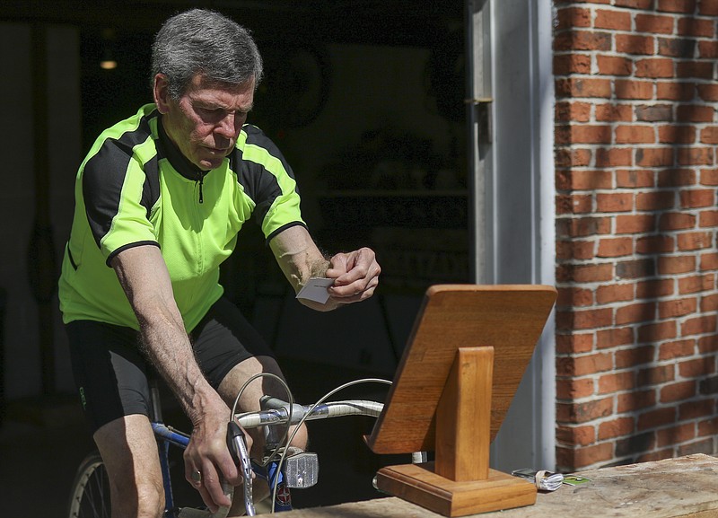 Liv Paggiarino/News TribuneJohn Howland works out on his stationary bike Friday while quizzing himself on different types of Ecuadorian birds at his home. Howland, an avid birder, runner and banjo player, is a man of many hobbies. He’s hoping to travel to Ecuador soon for some birding. In fact, Ecuador, he said, is one of his favorite places to go.