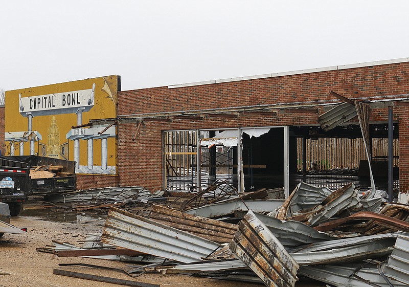 Liv Paggiarino/News TribuneThe interior of Capital Bowl, which was severely damaged in the May 2019 tornado, lies empty and gutted Wednesday afternoon, with bits of material strewn around the front entrance. The seemingly destructive site is actually a sign of good news — the property has been bought and will be rebuilt into a new bowling alley and arcade. The wooden skeleton of some rebuilt walls have already been put up; the new owners said they plan to gut the interior and cover the exterior with new materials as part of the renovation process.