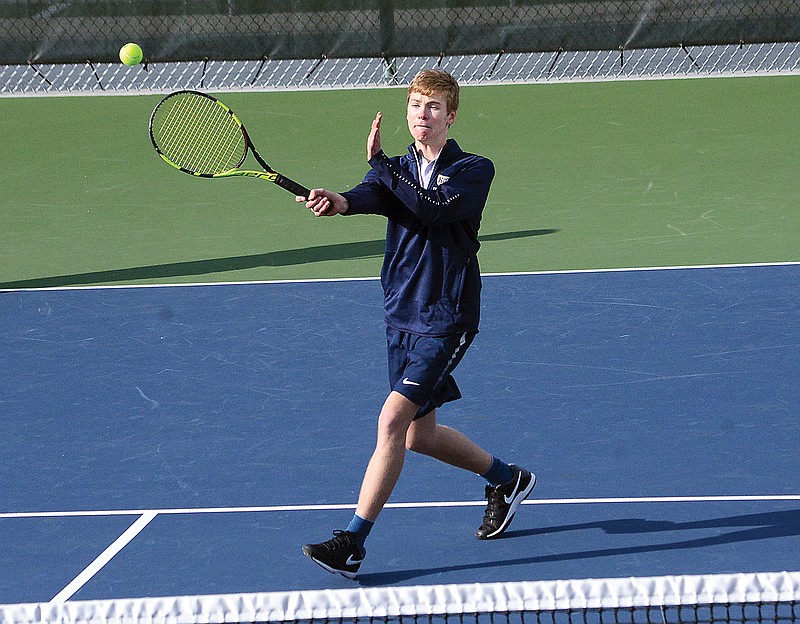 Justin Francka of Helias hits a forehand shot during a 2019 match against Moberly at the Crusader Athletic Complex.