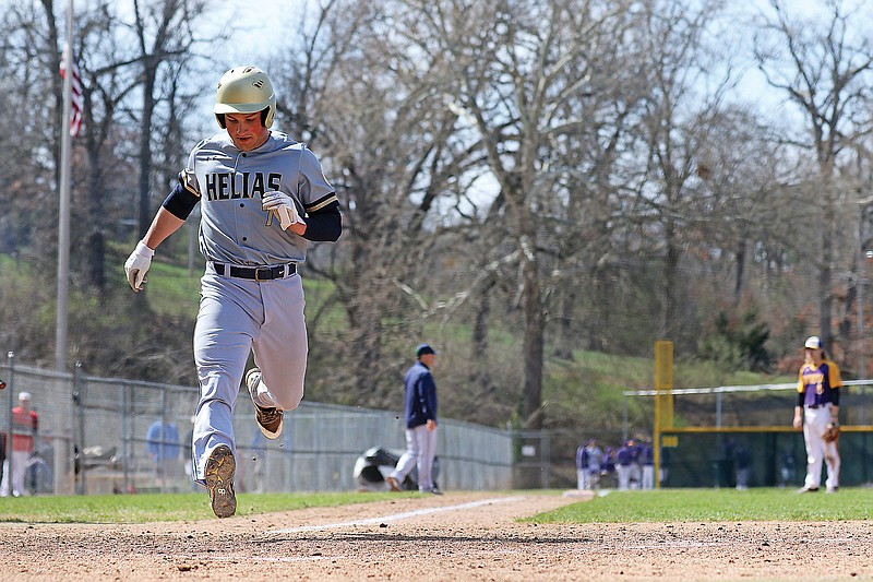 In this 2019 file photo, Jacob Weaver of Helias crosses the plate for a run during a Capital City Invitational game against Eureka at Vivion Field.