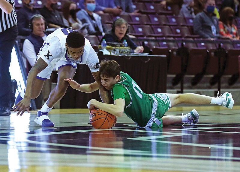 Quinn Kusgen of Blair Oaks dives to the floor to grab a loose ball from Vashon's Keshon Gilbert during Friday's Class 4 semifinal at JQH Arena in Springfield.