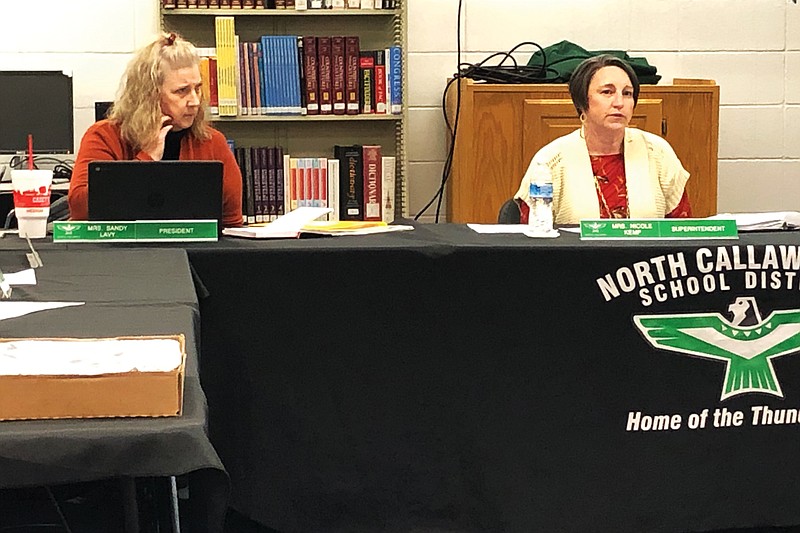 North Callaway R-1 school board president Sandy Lavy, left, listens while Superintendent Nicky Kemp gives a report during Thursday night's board meeting in the high school's media center.