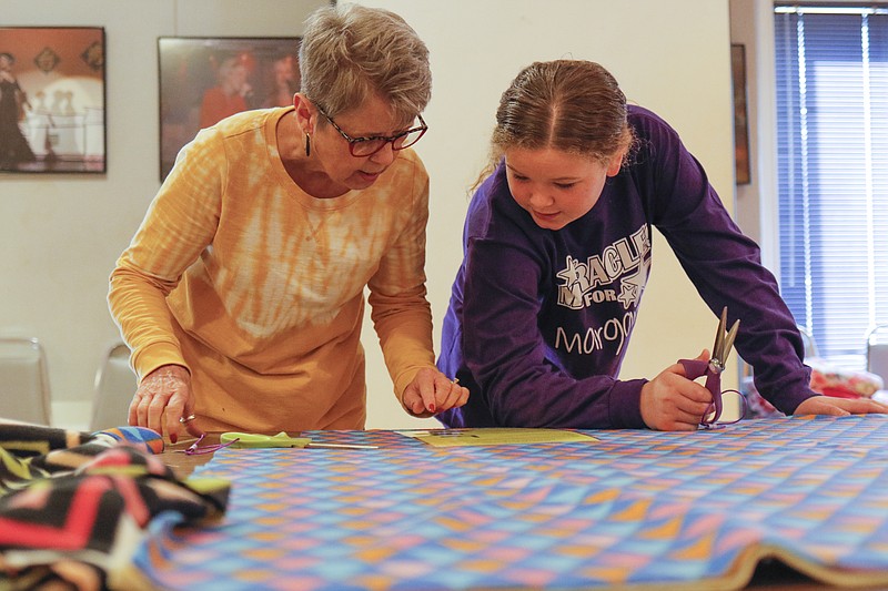 Liv Paggiarino/News Tribune

Linda Strange and her granddaughter, Paige Peters, 10, read the directions for the next step in creating their blankets for the Make-A-Blanket fundraiser for the Miracles 4 Margaret Foundation on Saturday at the Capital Ritz Banquet & Dance Center. Strange said that she and Paige are both fans of craft projects, and that this fundraiser was a great way for them to do something together for a good cause.