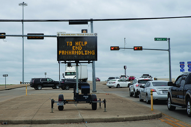  A sign put up by Texarkana Texas Police Department displays a message to drivers on Friday afternoon about panhandling in the area at Richmond Road and Mall Drive.